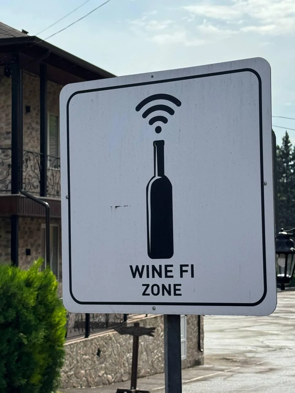 Wine Fi Zone sign with bottle and wifi symbol at a modern winery venue